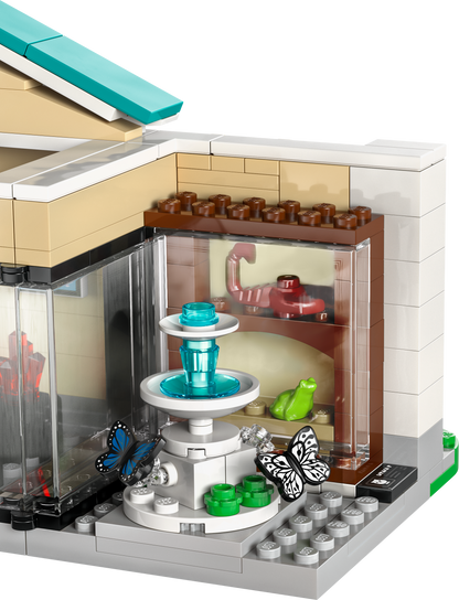 Lego building set with a detailed fountain, butterflies, and display shelves for creative play