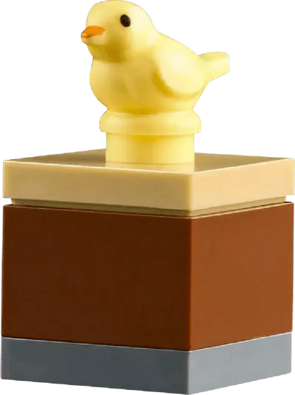 Cute yellow bird figure on a brown and tan LEGO piece for the LEGO botanical garden set