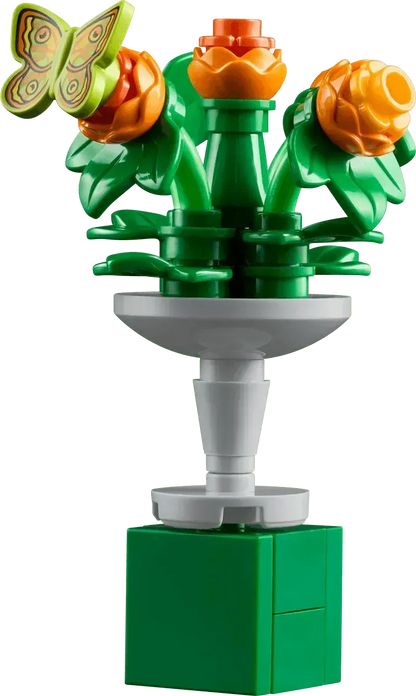 Colorful Lego botanical garden flower arrangement with green leaves and a butterfly decoration