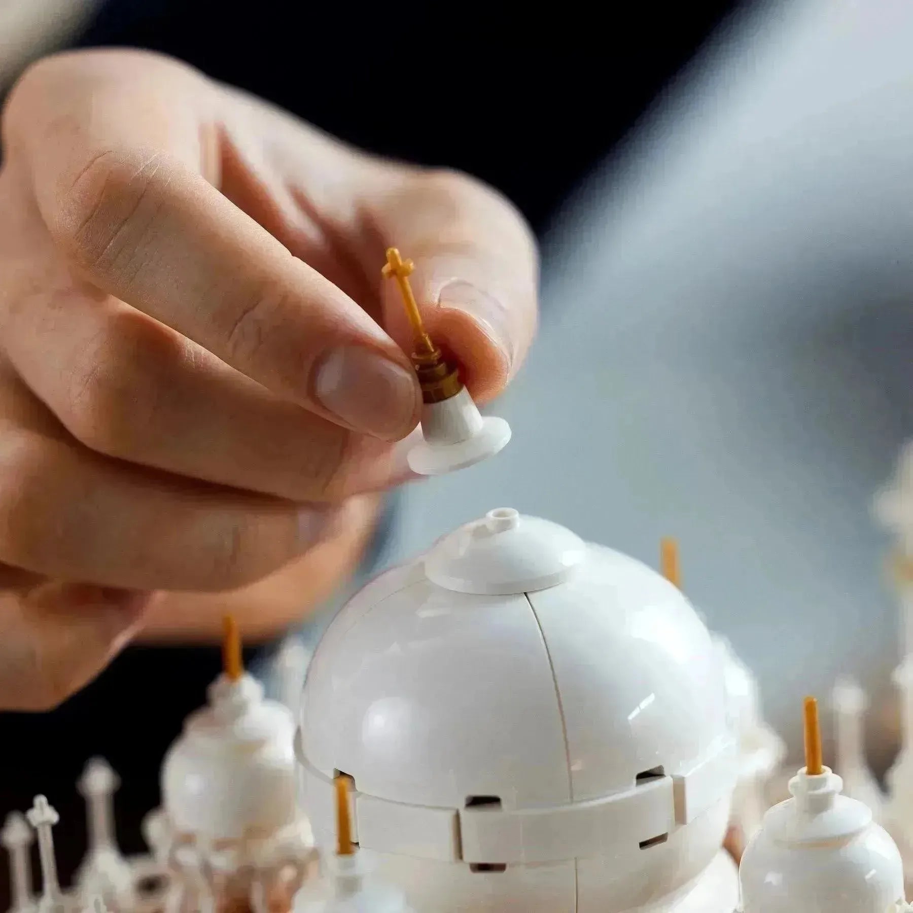 Building a LEGO Architecture model of the Taj Mahal with detailed white domes and gold accents